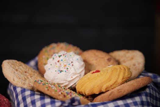 A close-up of a delicious assortment of cookies and biscuits on a checkered cloth.